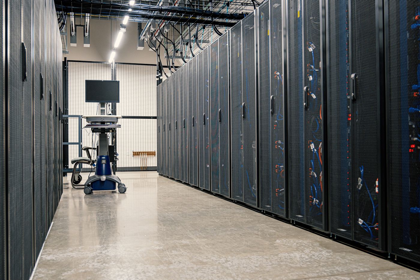 Server cabinets in a dark data centre. Editorial stock photograph.