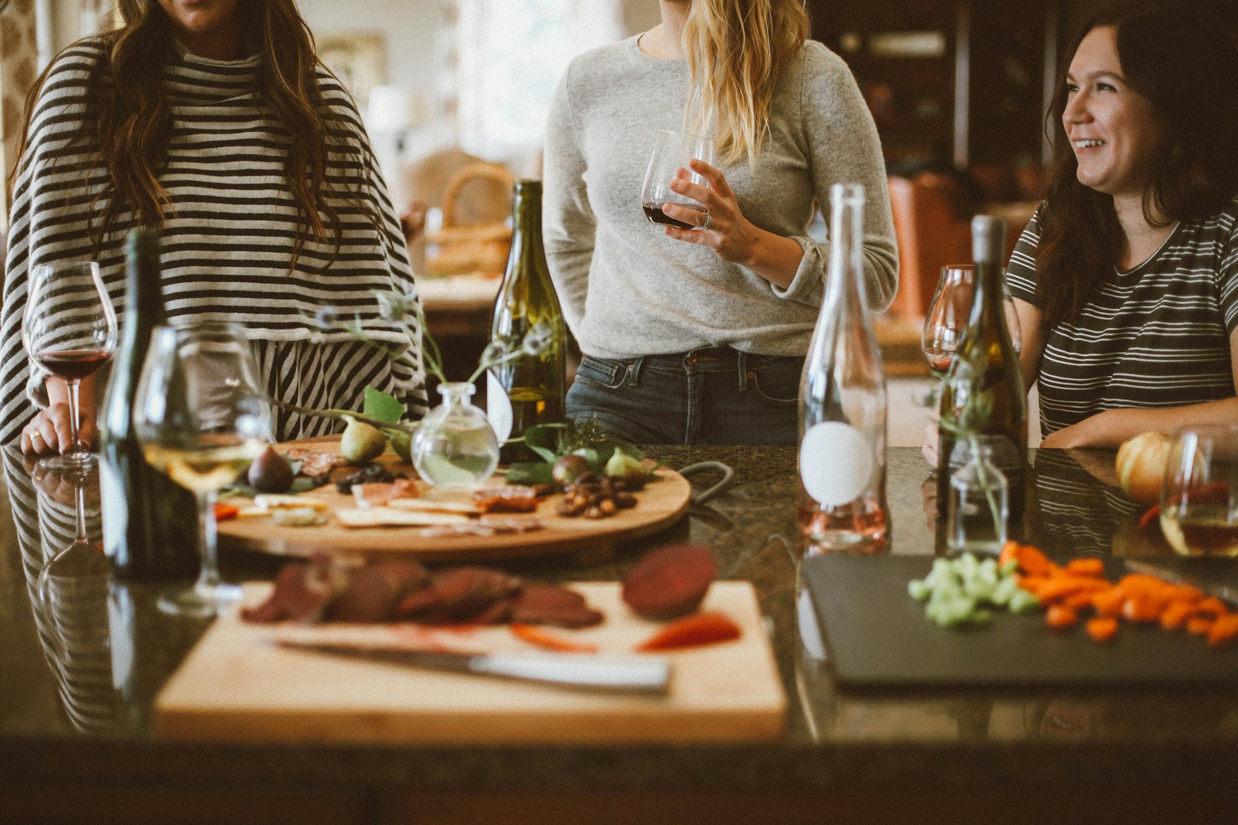 Friends sharing food and conversation at home.